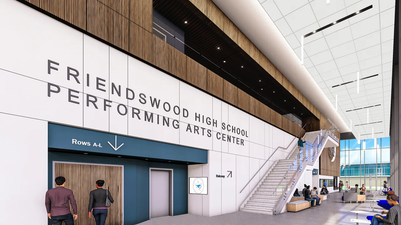 A glazed performing arts lobby includes timber walls and an open stair.