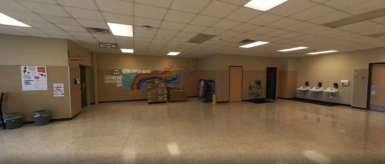The original open school lobby with drinking fountains and painted walls.